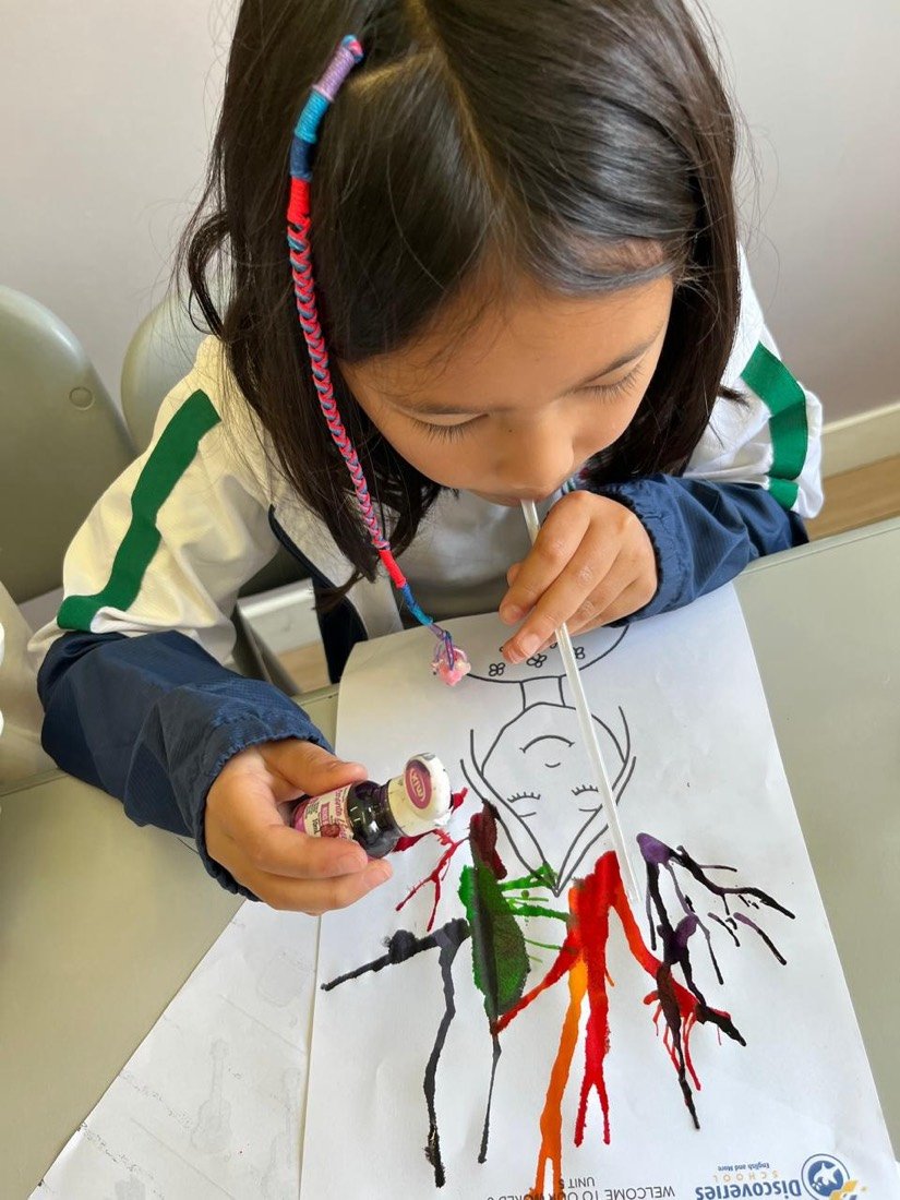 Aluna criando uma pintura em projeto de artes na Discoveries